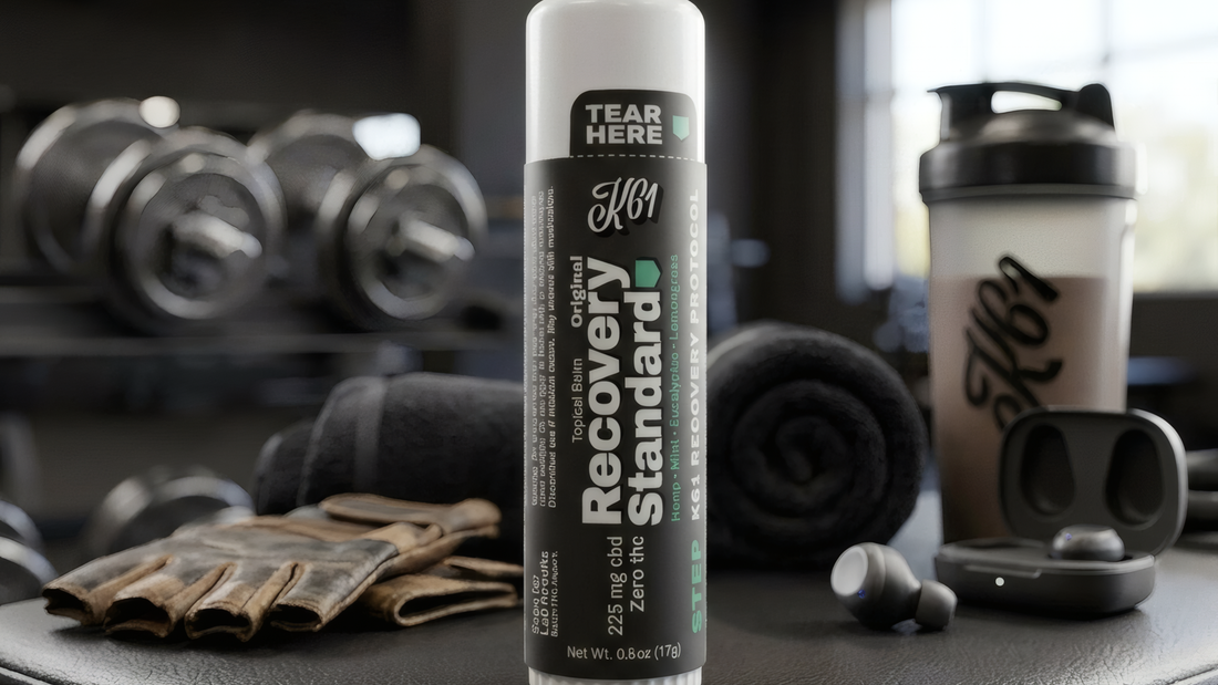 K61 Recovery Standard balm stick on a weight bench in a gym, CBD isolate with zero THC
