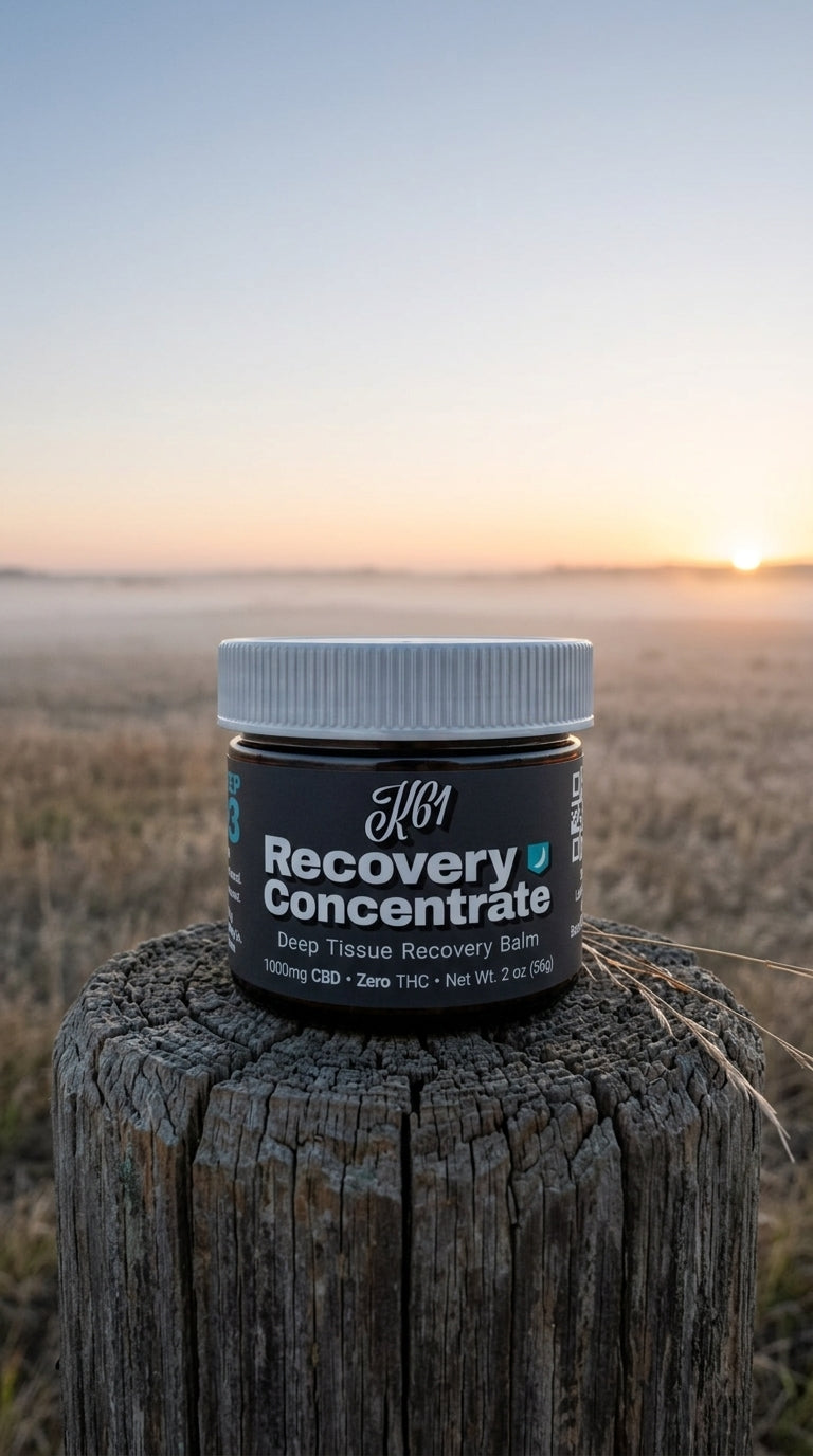 K61 Recovery Concentrate balm jar on a cedar fence post at dawn with prairie mist